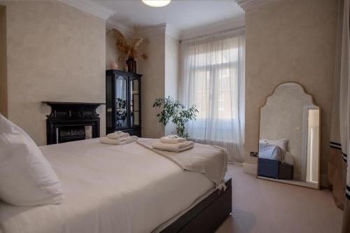 a bedroom with a large bed with towels on it at Sycamore House in York