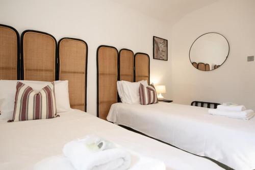 two beds sitting next to each other in a room at Sycamore House in York