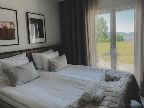 a bedroom with a bed with towels on it at Siljansnäs Hotell in Siljansnäs