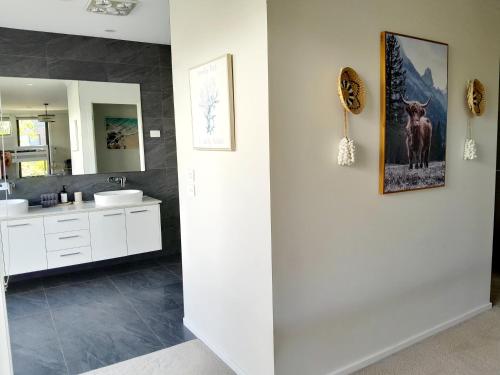 a bathroom with two sinks and a mirror at Luxury House Boho Seaside in Cowes