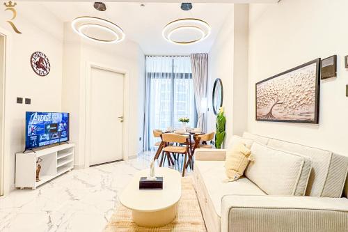 a white living room with a couch and a table at Chic Modern 1BR - Executive Al Maryah Stay in Abu Dhabi
