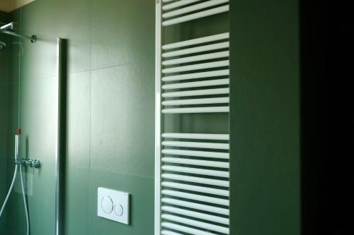 a bathroom with a shower and a towel rack at Suite Cecilia by Piazza del Lago, Como Center in Como
