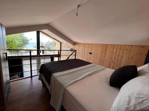 a bedroom with a bed and a large window at Mavi Apart in Demre