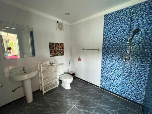 a bathroom with a shower and a toilet and a sink at TopCats Fishing Resort in Taling Ngam Beach