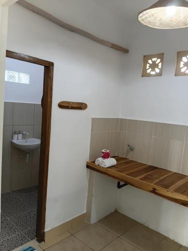 a bathroom with a sink and a wooden counter at Tapada in Gili Islands