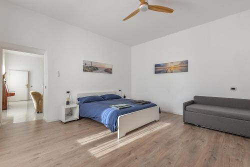 a bedroom with a bed and a couch at A Casa di Nonna Anna in Porto Azzurro