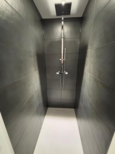 a bathroom with a shower with a light in it at Maison Floréal Giverny in Giverny