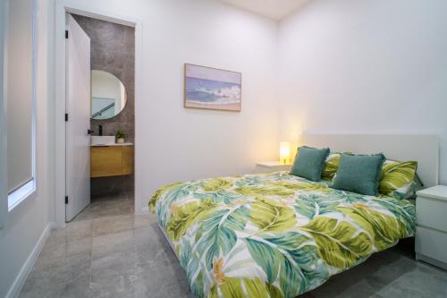 a bedroom with a bed and a bathroom at Brand New Elegant House in Marsden Park