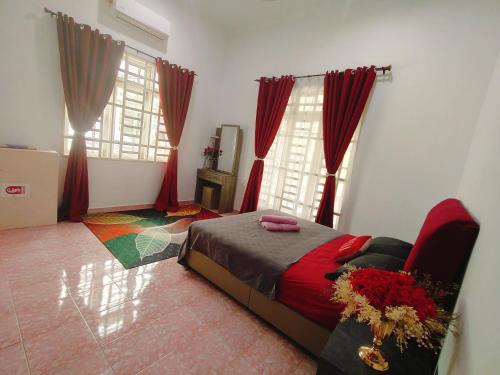 a bedroom with a bed and two windows with red curtains at Redhousehomestay in Kota Bharu