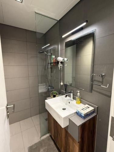 a bathroom with a sink and a mirror at Modern studio Al mamsha by Alef in Sharjah