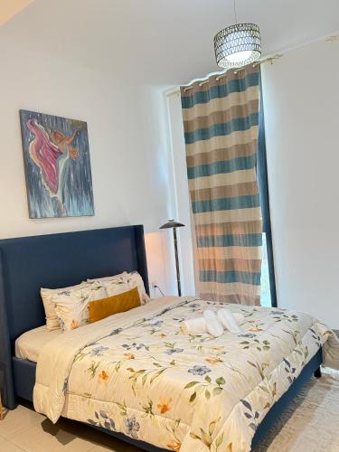 a bedroom with a bed and a window at Modern studio Al mamsha by Alef in Sharjah