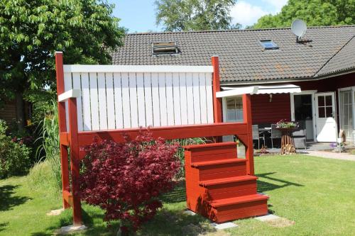 a large red bench in front of a house at Holthus in Kollmar