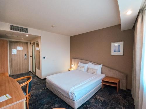 Voodi või voodid majutusasutuse Triada Hotel toas