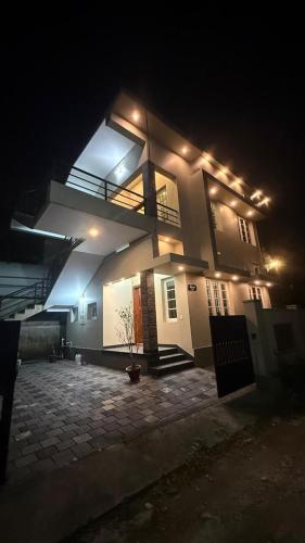 a house lit up at night with lights on it at sahara private villa in Cochin