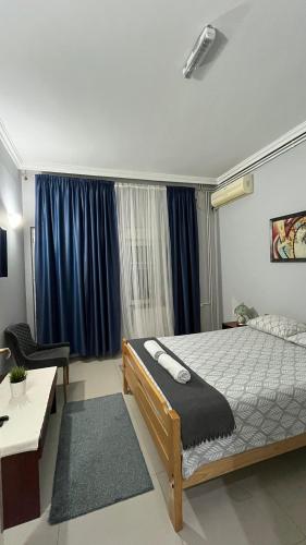 a bedroom with a bed and a desk and a window at Vila Eni in Smederevo