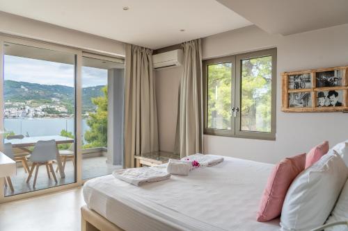a bedroom with a bed and a table with a view at Core Luxury Suites in Skiathos