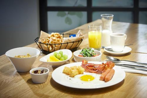 a table with a plate of breakfast food and drinks at Hotelaround Forest in Pyeongchang