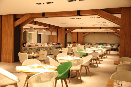 an empty dining room with tables and chairs at Hotelaround Forest in Pyeongchang