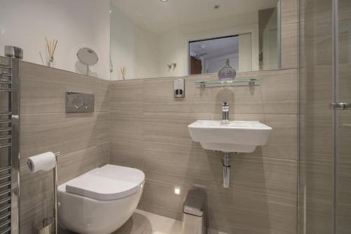 a bathroom with a toilet and a sink at ChocoLets - The Quality Suite in York