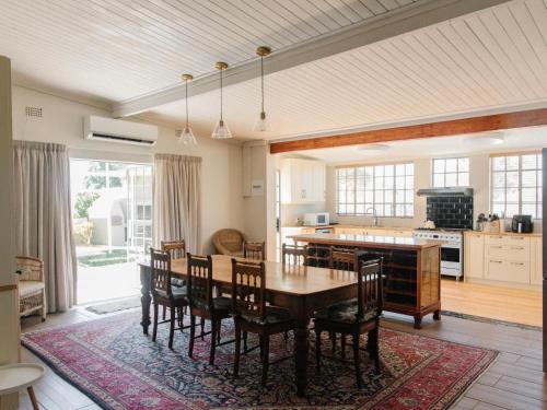a kitchen and dining room with a table and chairs at Kokerboom House in Vanrhynsdorp