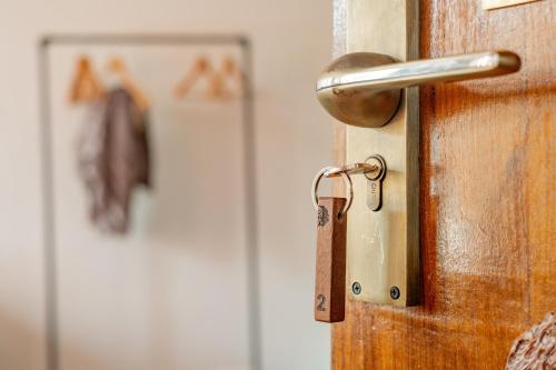a wooden door with a key on it at Ethico Retreat Formely Five14 BnB in Pātan