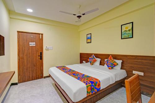 a bedroom with a large bed in a room at FabHotel SRP in Hyderabad