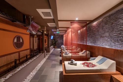 a room with four beds and a brick wall at Limak Limra Hotel & Resort Kemer - Kids Concept in Kemer