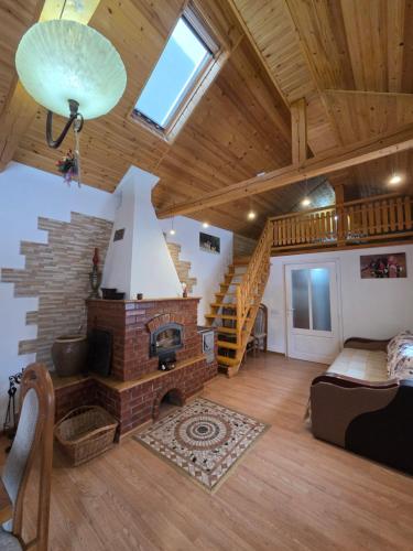 a living room with a brick fireplace in a house at Casa DelCris in Pojorâta