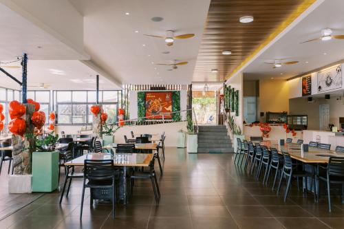 a dining room with tables and chairs in a restaurant at Serenity Busay Room 3 in Cebu City