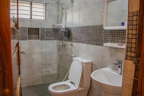 a bathroom with a toilet and a sink at Shangani Hotel in Zanzibar City