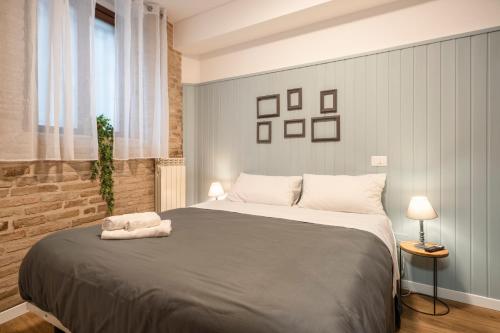 a bedroom with a large bed with two towels on it at Maison all'Arco in Corridonia