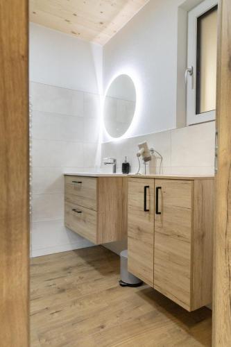 a bathroom with a sink and a mirror at Huawa Appartements in Öblarn