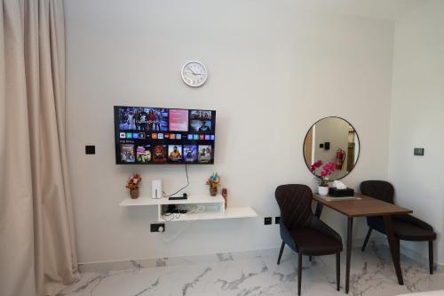 a bathroom with a table and two chairs and a mirror at Al Maryah Studio near Cleveland and Galleria Mall by Central Stay in Abu Dhabi