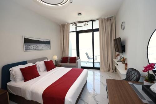 a bedroom with a large bed with red pillows at Al Maryah Studio near Cleveland and Galleria Mall by Central Stay in Abu Dhabi
