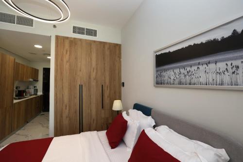 a bedroom with a bed and a painting on the wall at Al Maryah Studio near Cleveland and Galleria Mall by Central Stay in Abu Dhabi
