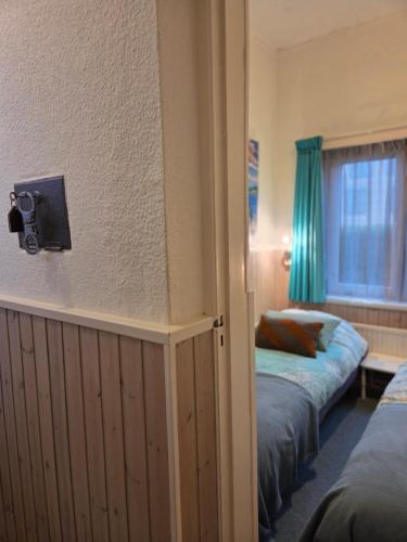 a hotel room with two beds and a window at Riposo in West-Terschelling