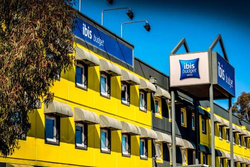 a yellow building with a bus depot sign on it at ibis Budget - Fawkner in Melbourne