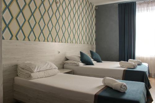 three beds in a room with a window at Rivne Hostel in Rivne