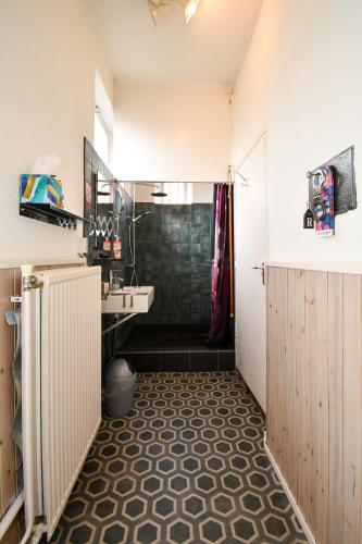 a bathroom with a sink and a shower at Riposo in West-Terschelling