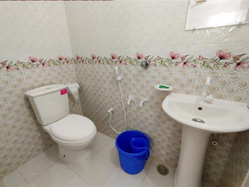 a bathroom with a toilet and a sink at Hotel Dhanmondi Prime in Dhaka