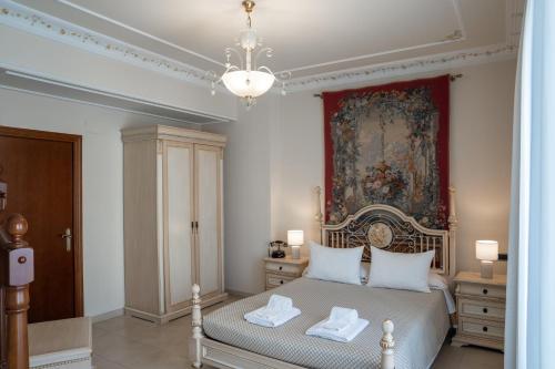 a bedroom with a bed with a painting on the wall at Hotel Kazar in Ontinyent