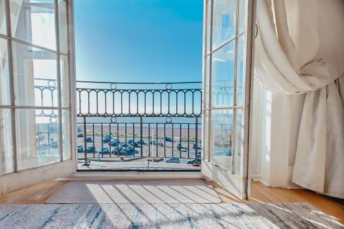 an open window with a view of a city at The Pelham Penthouse in Hastings