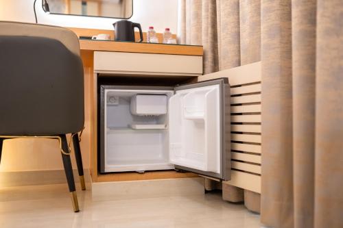an open refrigerator sitting next to a counter at Smana Hotel Al Raffa in Dubai