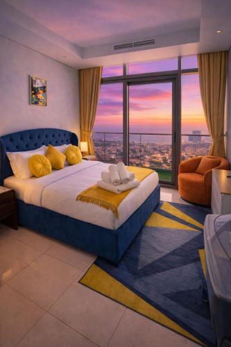 a bedroom with a large bed with a view at 2BR Burj Khalifa and Sea View Apartments in Paramount Hotel Midtown in Dubai