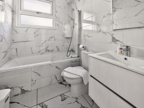 a white bathroom with a toilet and a sink at Alassia Blue Villa in Protaras