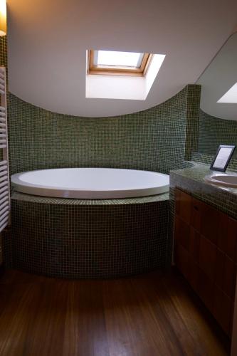 a bathroom with a tub and a sink at B & B Paradiso in Loreto