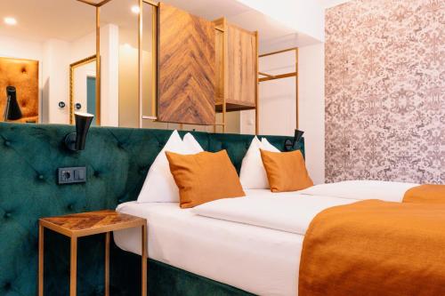 a hotel room with two beds and a table at Hotel Palais26 in Villach