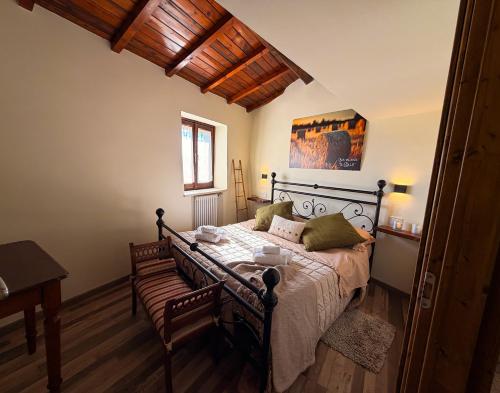 a bedroom with a bed and a table and a window at IL COLLE Holiday Home - FIUGGI - Charming independent home in the historic center, near the Thermal Baths & Wellness Retreats in Fiuggi