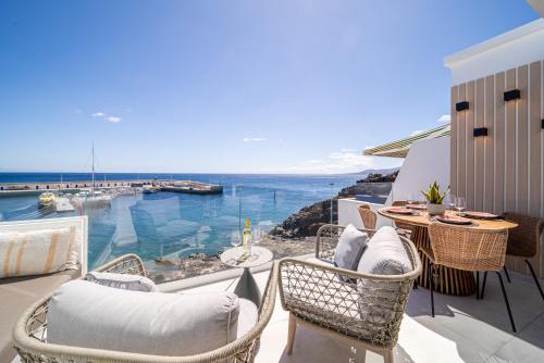 a patio with a table and chairs and the ocean at Casa Breca in Puerto del Carmen