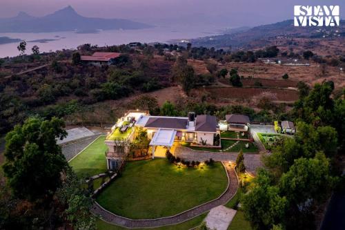 an aerial view of a house on a hill at StayVista at Beyond Infinity with Hill View, BBQ in Lonavala